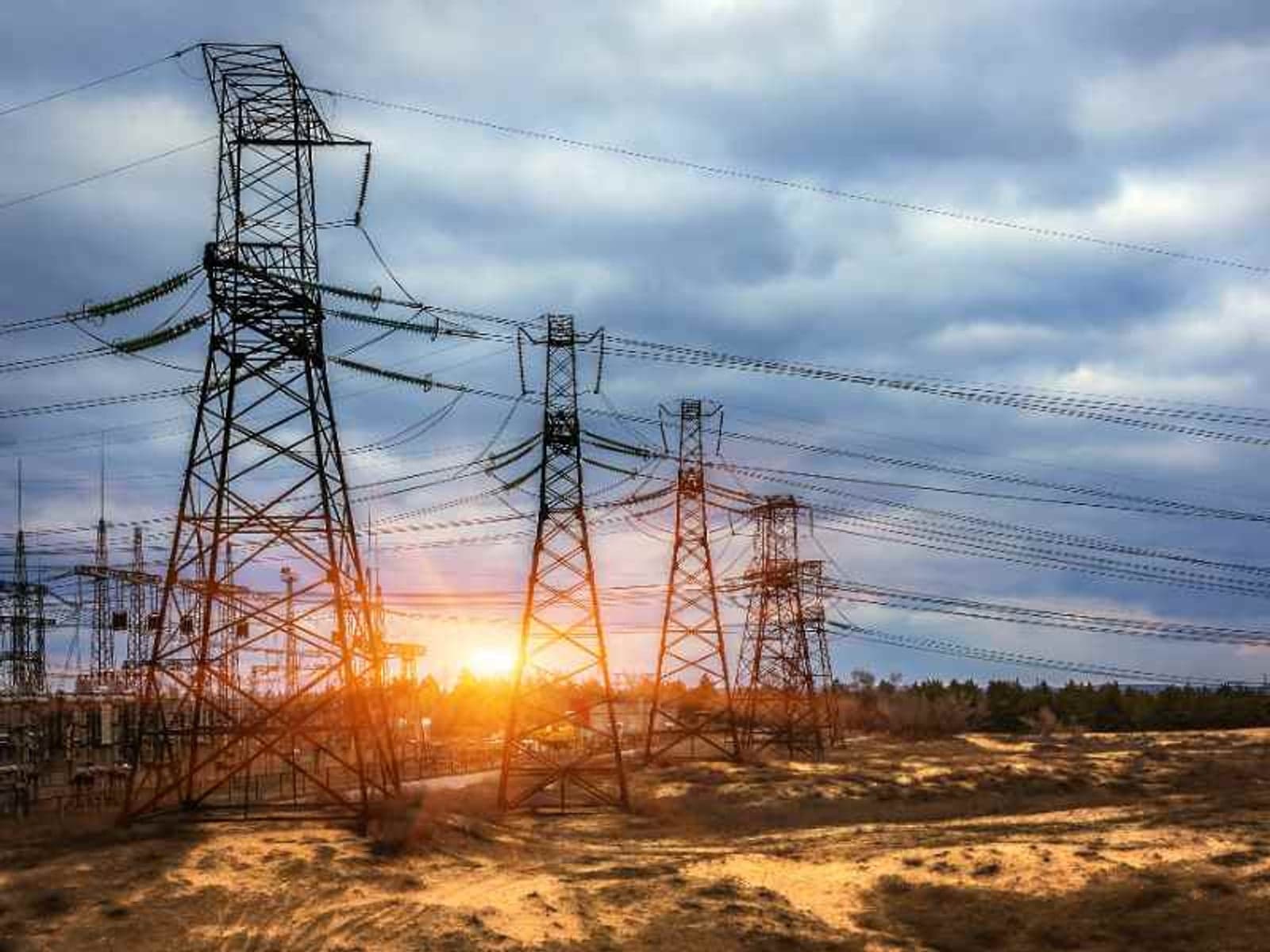 cascade of  high-voltage  power lines. electricity distribution station at sunset.